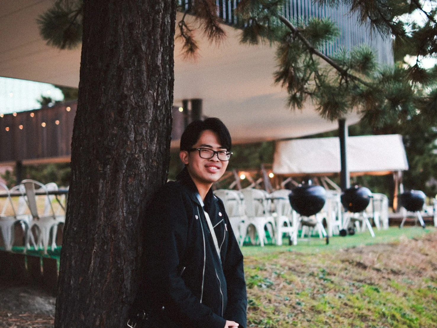 Yuto Matsui standing beside pine trees